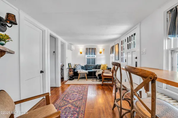 a living room with fireplace furniture and a wooden floor
