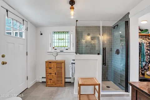 a bathroom with a shower a sink and a mirror