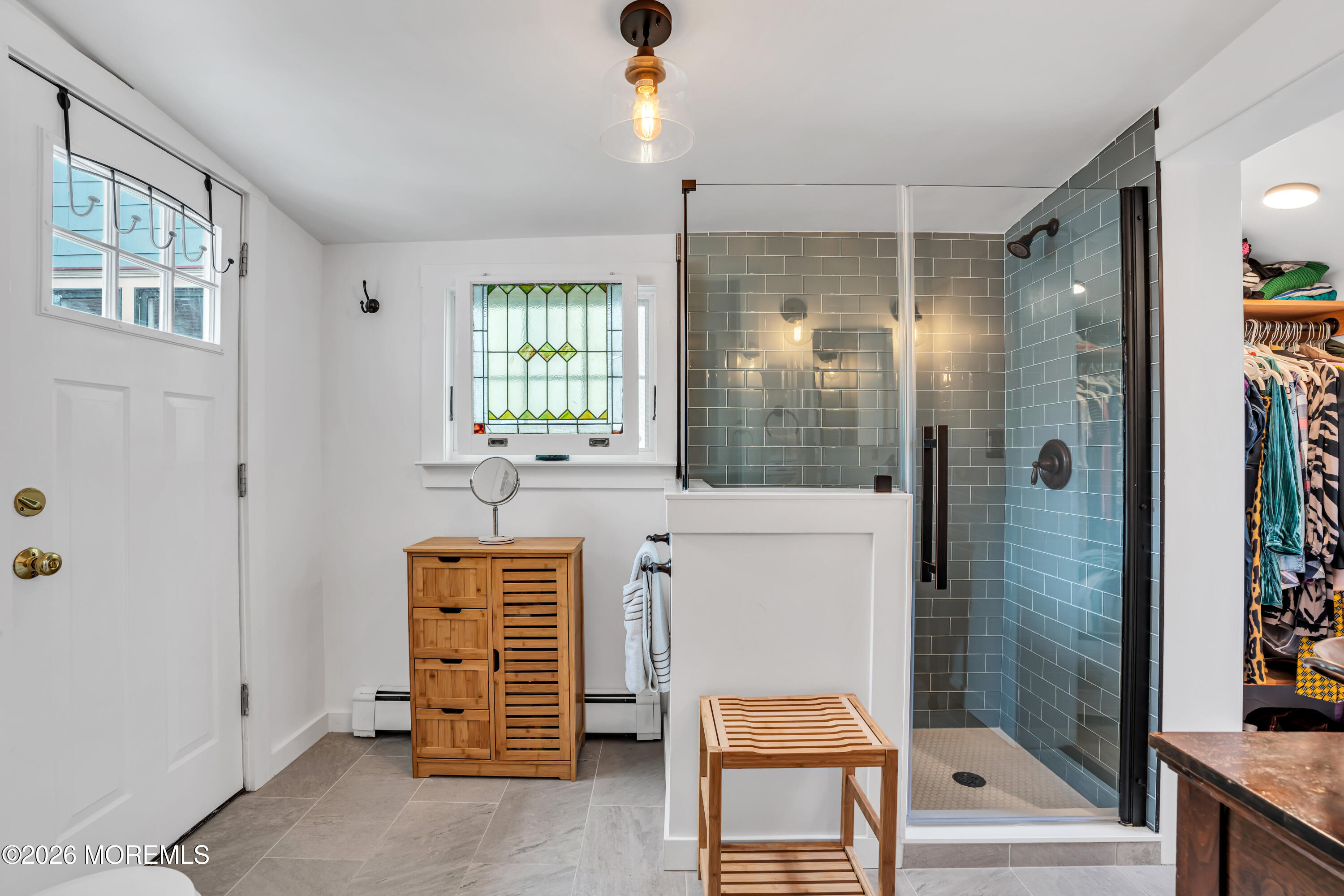 119 Pilgrim Pathway Ocean Grove, NJ 07756 - Photo 22 of 26 a bathroom with a shower a sink and a mirror