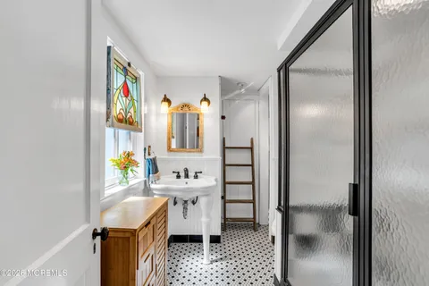 a room with stainless steel appliances a refrigerator and a sink