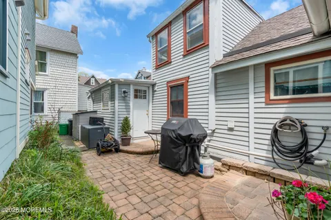 a view of backyard with barbeque grill and a fireplace