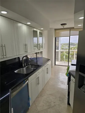 a kitchen with stainless steel appliances a refrigerator and a sink