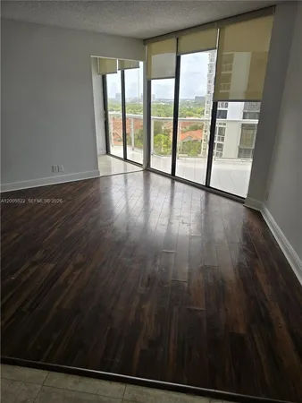 an outdoor view with wooden floor and windows