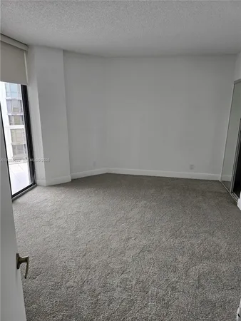 a view of an empty room with a large window