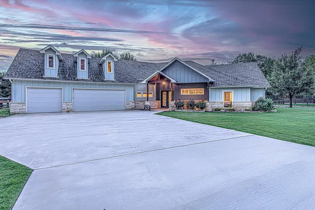 a front view of house with yard and green space