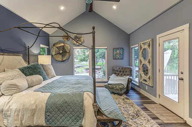 a bathroom with a granite countertop sink a large mirror and a bathtub