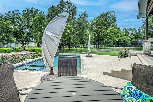 a view of a swimming pool and a yard