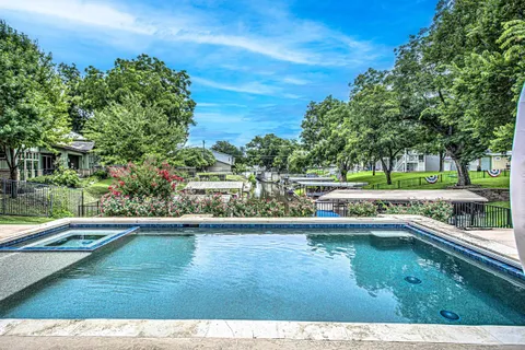 a view of a house with a yard and sitting area