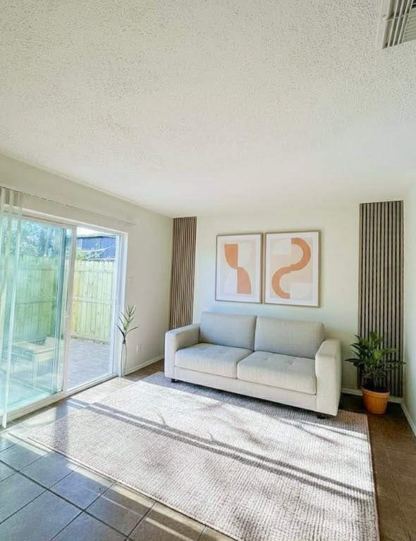 5810 Sweeney Circle, Unit D Austin, TX 78723 - Photo 1 of 18 Living area featuring a textured ceiling