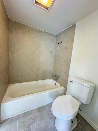 a bathroom with a toilet and a bathtub