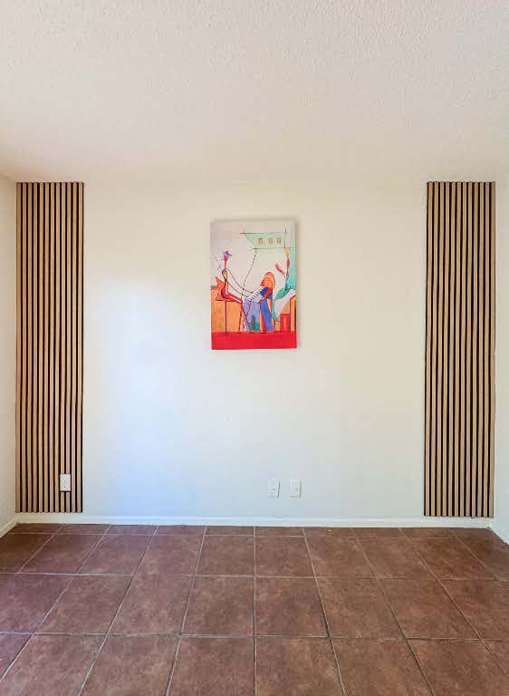 5810 Sweeney Circle, Unit D Austin, TX 78723 - Photo 3 of 18 Empty room with a textured ceiling and dark tile patterned floors