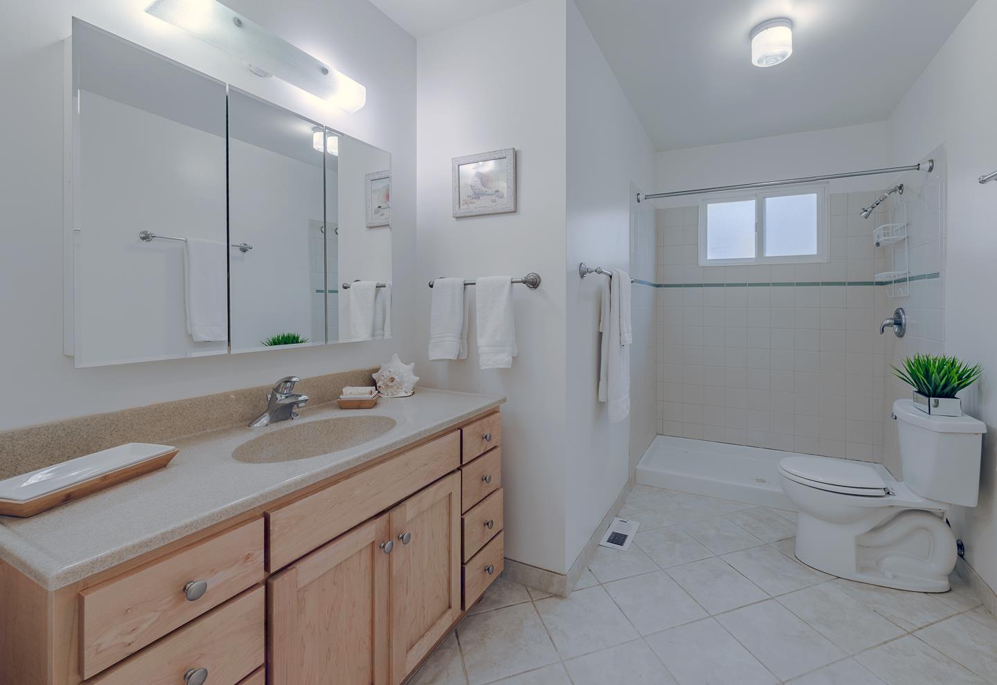 3350 Hardin Way Soquel, CA 95073 - Photo 17 of 45 a bathroom with a granite countertop sink a toilet and a mirror