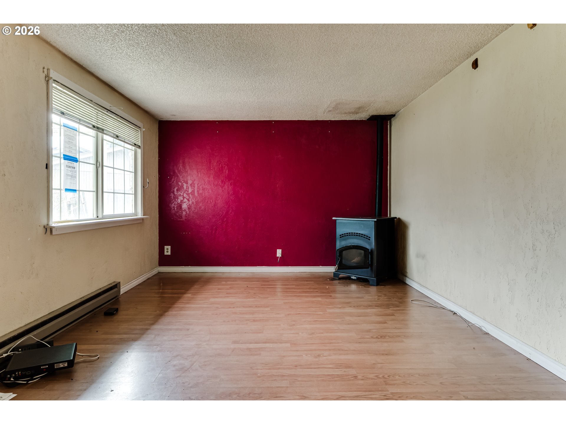 445 Southwest Juniper Street Junction City, OR 97448 - Photo 3 of 36 a view of an empty room with wooden floor and a window
