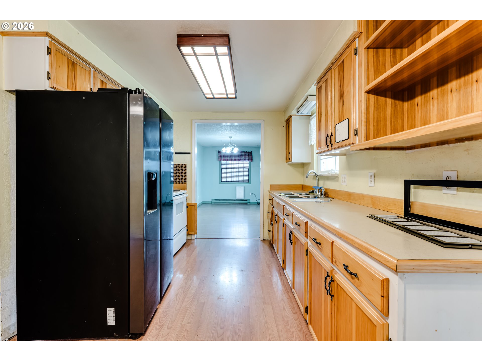 445 Southwest Juniper Street Junction City, OR 97448 - Photo 6 of 36 a kitchen with stainless steel appliances granite countertop a refrigerator a stove and a wooden floor
