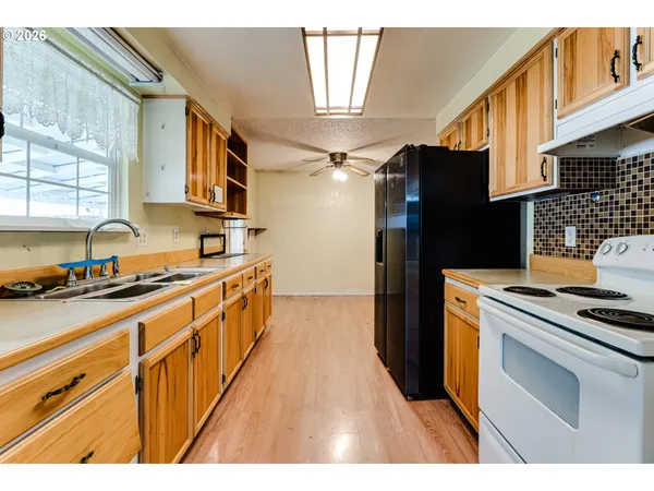 a kitchen with stainless steel appliances a stove a sink and a refrigerator