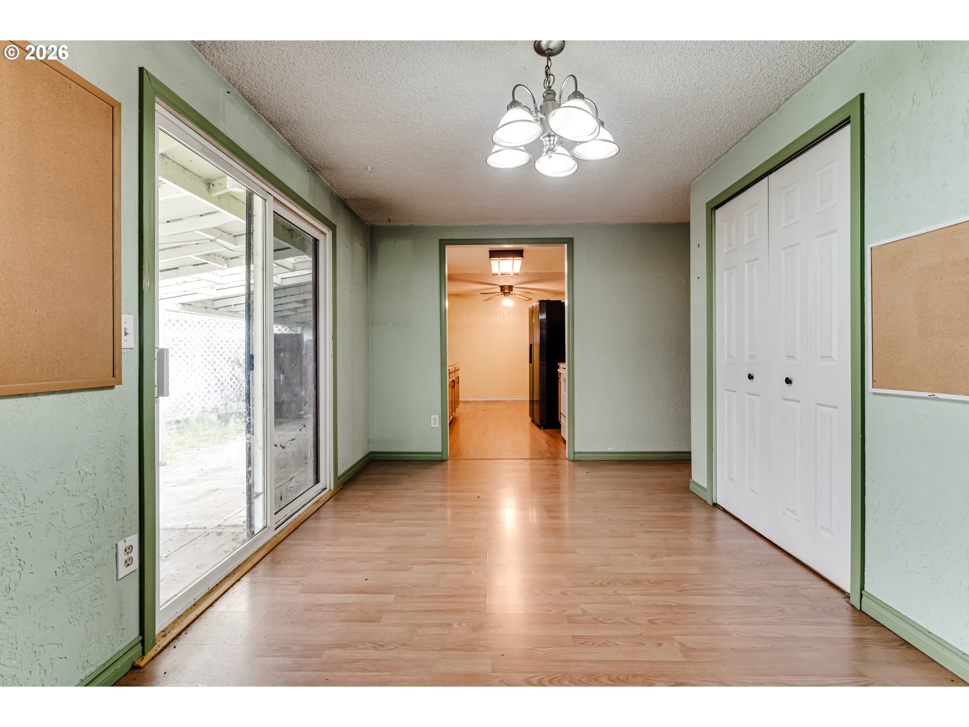445 Southwest Juniper Street Junction City, OR 97448 - Photo 10 of 36 a view of a hallway with wooden floor and chandelier