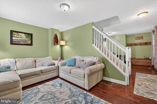 a living room with furniture and a stairs