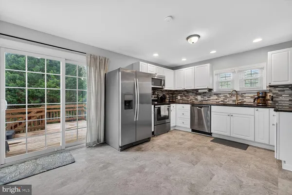 a kitchen with a refrigerator and window