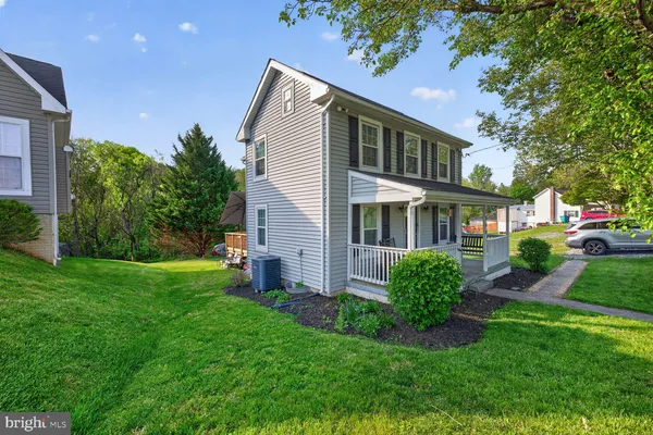 a front view of a house with a yard and porch