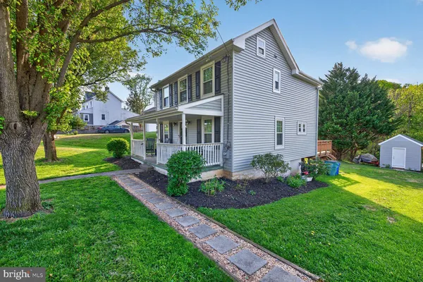 a front view of house with yard and green space