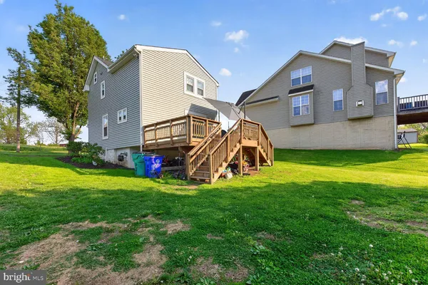 a view of a house with a big yard and a large tree