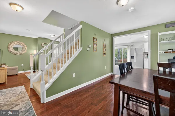 a view of a livingroom with furniture a dinning room and stairs