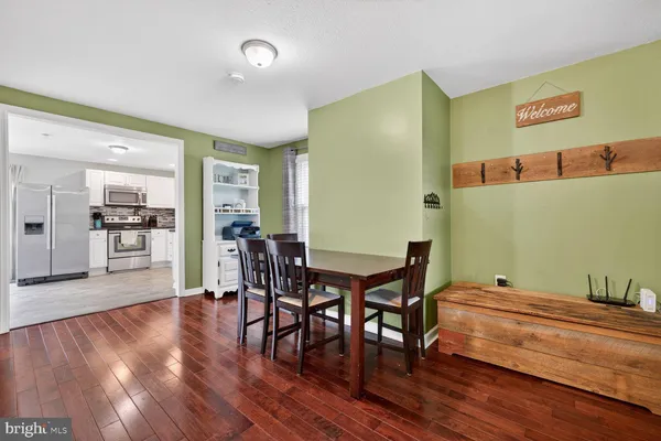 a view of dining room with furniture and wooden floor