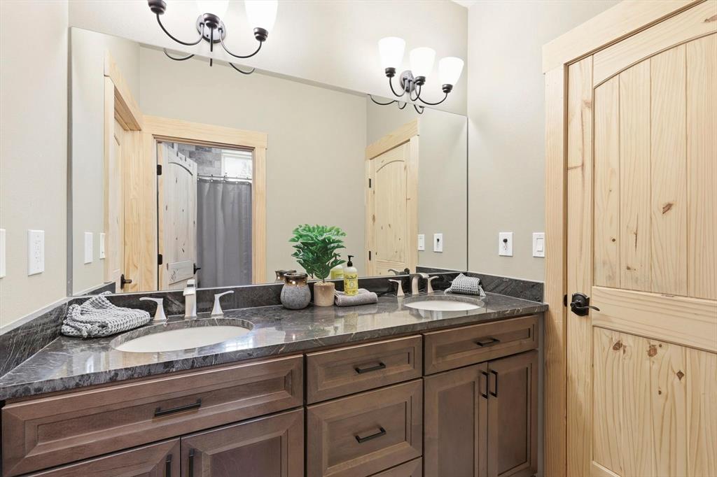 3300 Rigsby Lane Celina, TX 75009 - Photo 26 of 40 Bathroom featuring double vanity, a chandelier, and a shower with shower curtain