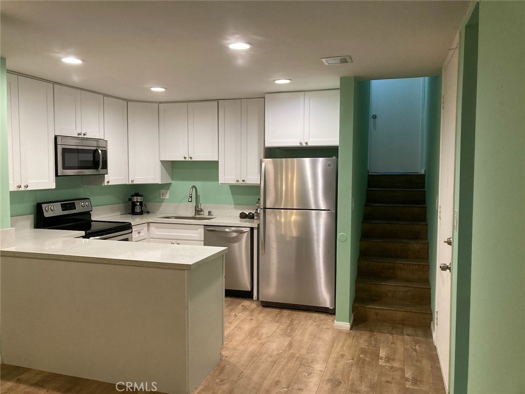 4545 Collwood Boulevard, Unit 19 San Diego, CA 92115 - Photo 12 of 20 a kitchen with refrigerator a microwave and sink