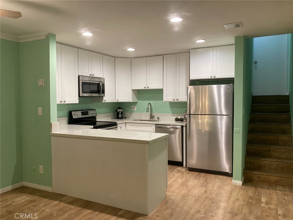 4545 Collwood Boulevard, Unit 19 San Diego, CA 92115 - Photo 13 of 20 a kitchen with kitchen island a refrigerator sink and stove