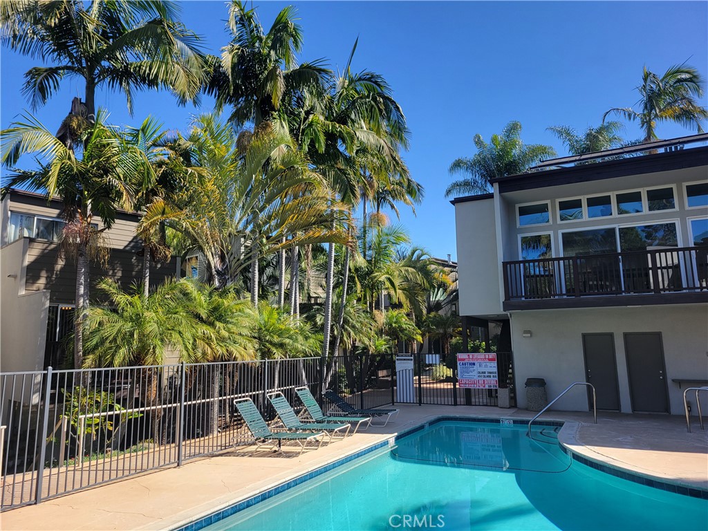 4545 Collwood Boulevard, Unit 19 San Diego, CA 92115 - Photo 2 of 20 a view of a swimming pool with a patio and a garden