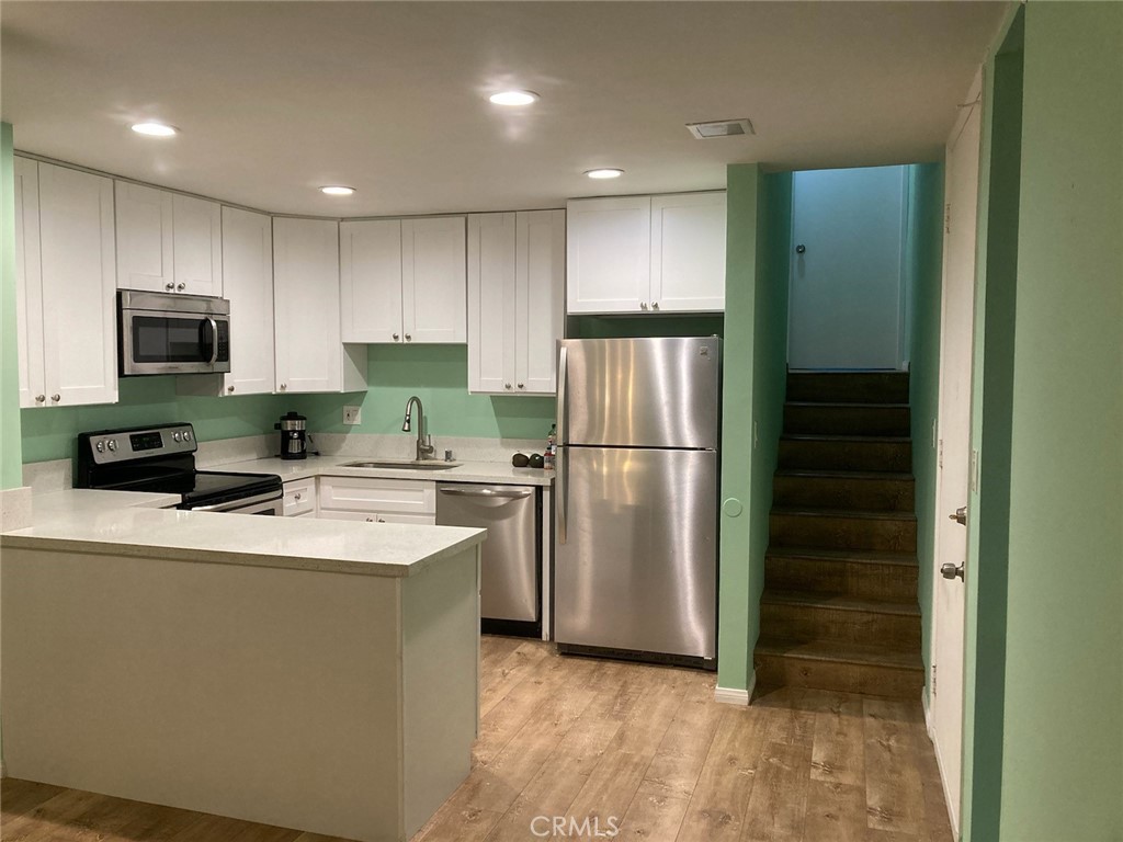 4545 Collwood Boulevard, Unit 19 San Diego, CA 92115 - Photo 3 of 20 a kitchen with a refrigerator a microwave and sink