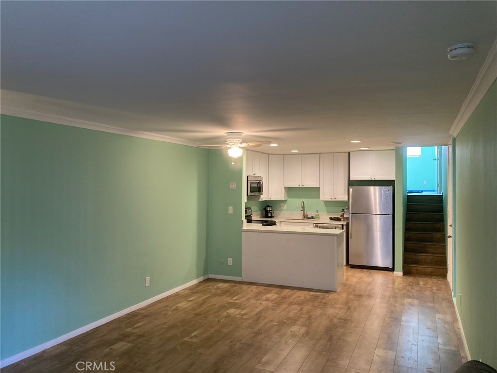 4545 Collwood Boulevard, Unit 19 San Diego, CA 92115 - Photo 4 of 20 a view of a kitchen with a sink and a refrigerator