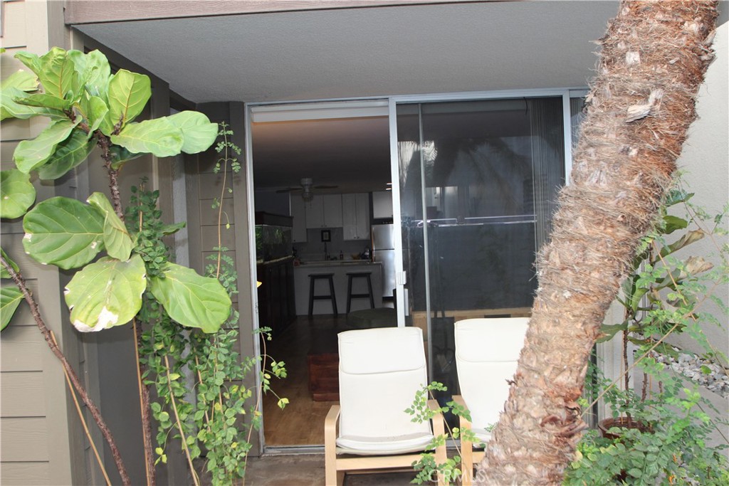 4545 Collwood Boulevard, Unit 19 San Diego, CA 92115 - Photo 10 of 20 a vase of flowers sitting on a table with a floor to ceiling window