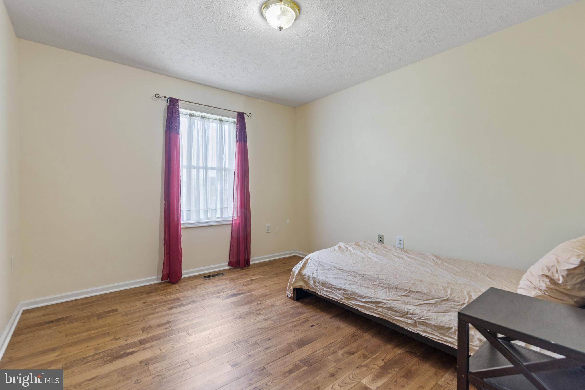 5 Hite Court Luray, VA 22835 - Photo 21 of 40 a bedroom with a bed and wooden floor