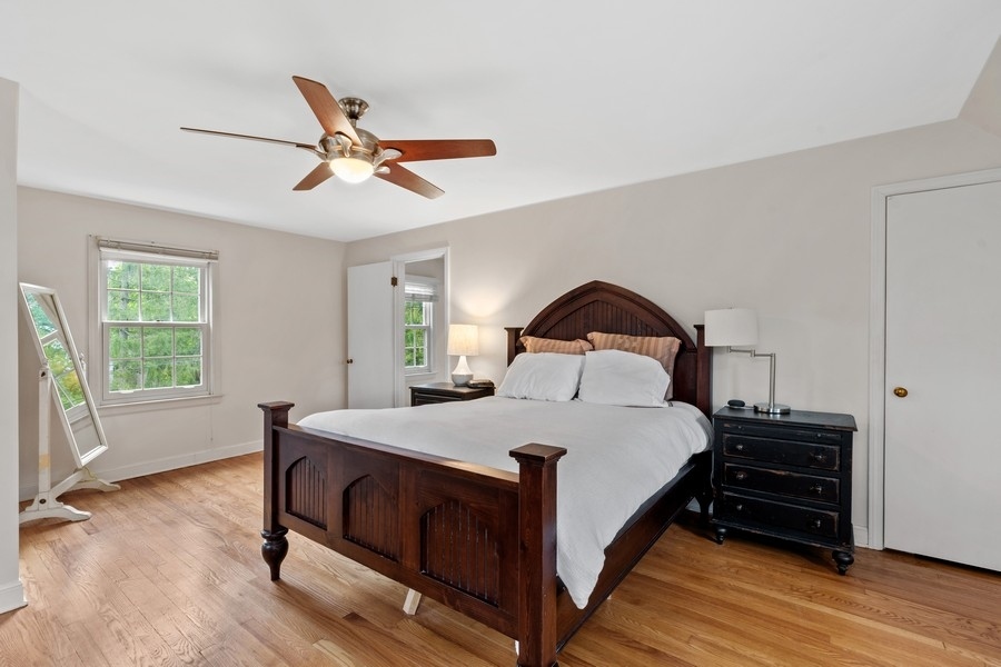 1806 Sunset Road Highland Park, IL 60035 - Photo 12 of 27 a bedroom with a bed and wooden floor