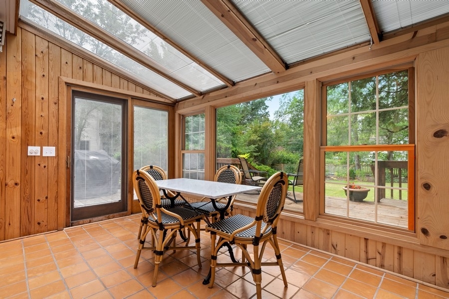 1806 Sunset Road Highland Park, IL 60035 - Photo 18 of 27 a view of a dining room with furniture large windows and wooden floor