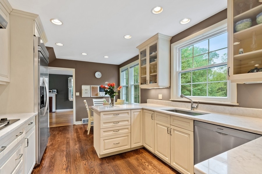 1806 Sunset Road Highland Park, IL 60035 - Photo 8 of 27 a kitchen with a sink window and cabinets