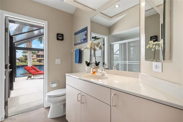 a bathroom with a sink vanity mirror and toilet