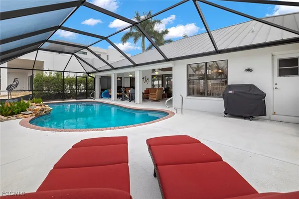 a view of a backyard with table and chairs under an umbrella