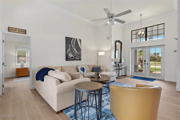 a living room with furniture and a chandelier