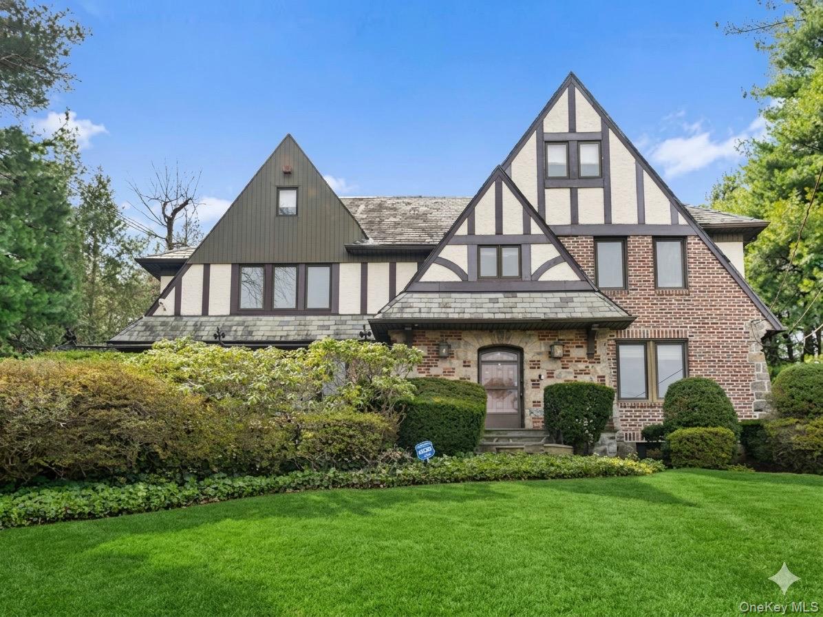 44 Fenimore Road New Rochelle, NY 10804 - Photo 2 of 46 a front view of a house with a yard and potted plants