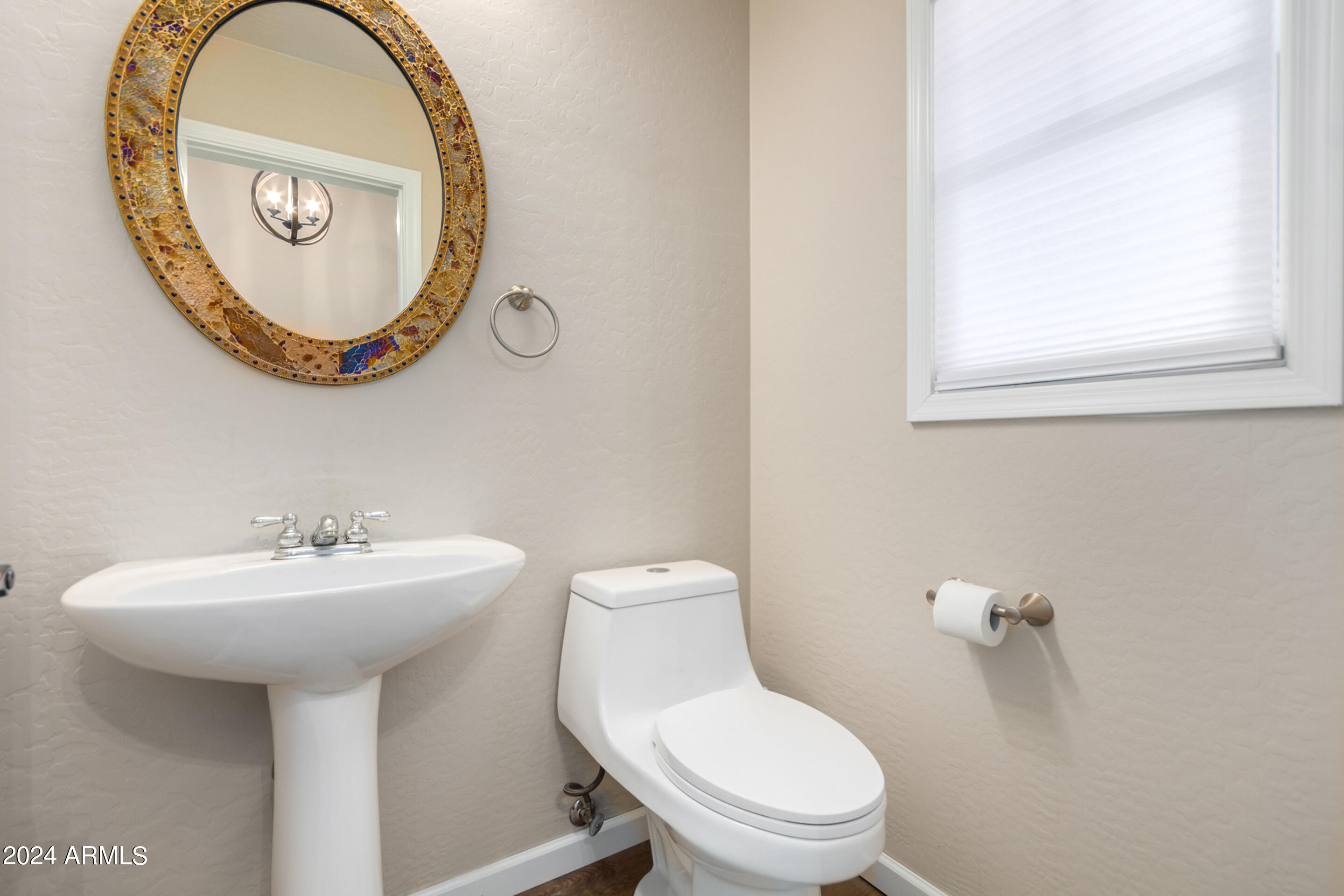 17149 West Rimrock Street Surprise, AZ 85388 - Photo 14 of 46 a bathroom with a toilet sink and a mirror