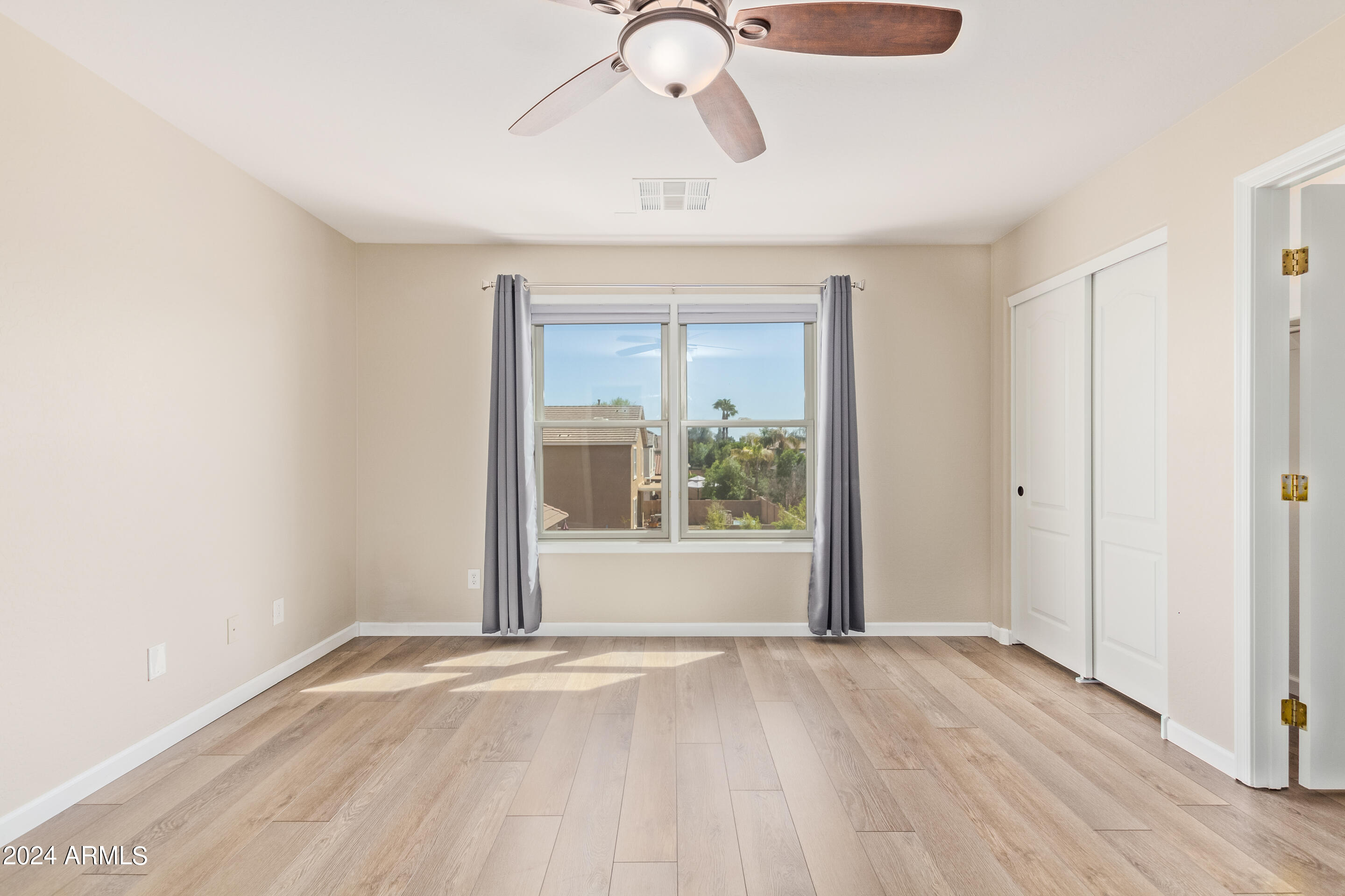 17149 West Rimrock Street Surprise, AZ 85388 - Photo 15 of 46 an empty room with wooden floor and windows