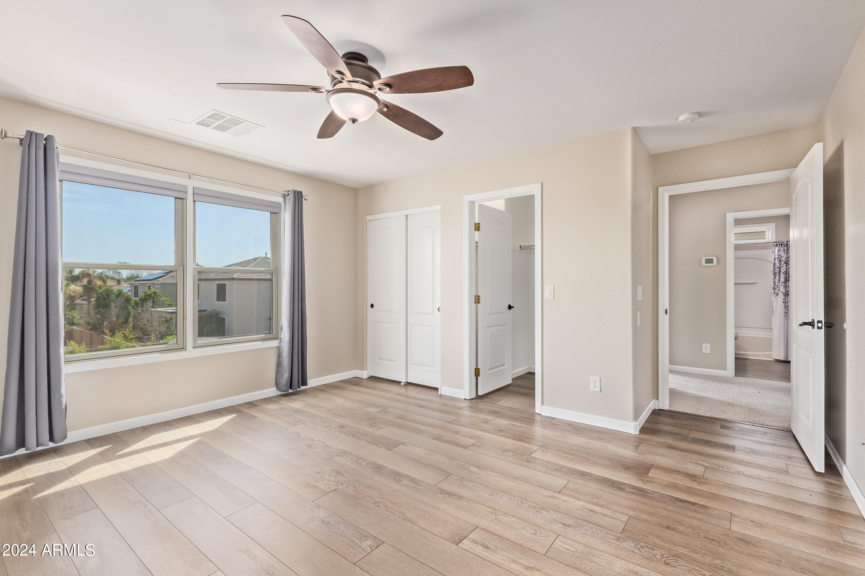 17149 West Rimrock Street Surprise, AZ 85388 - Photo 16 of 46 a view of empty room with wooden floor and fan