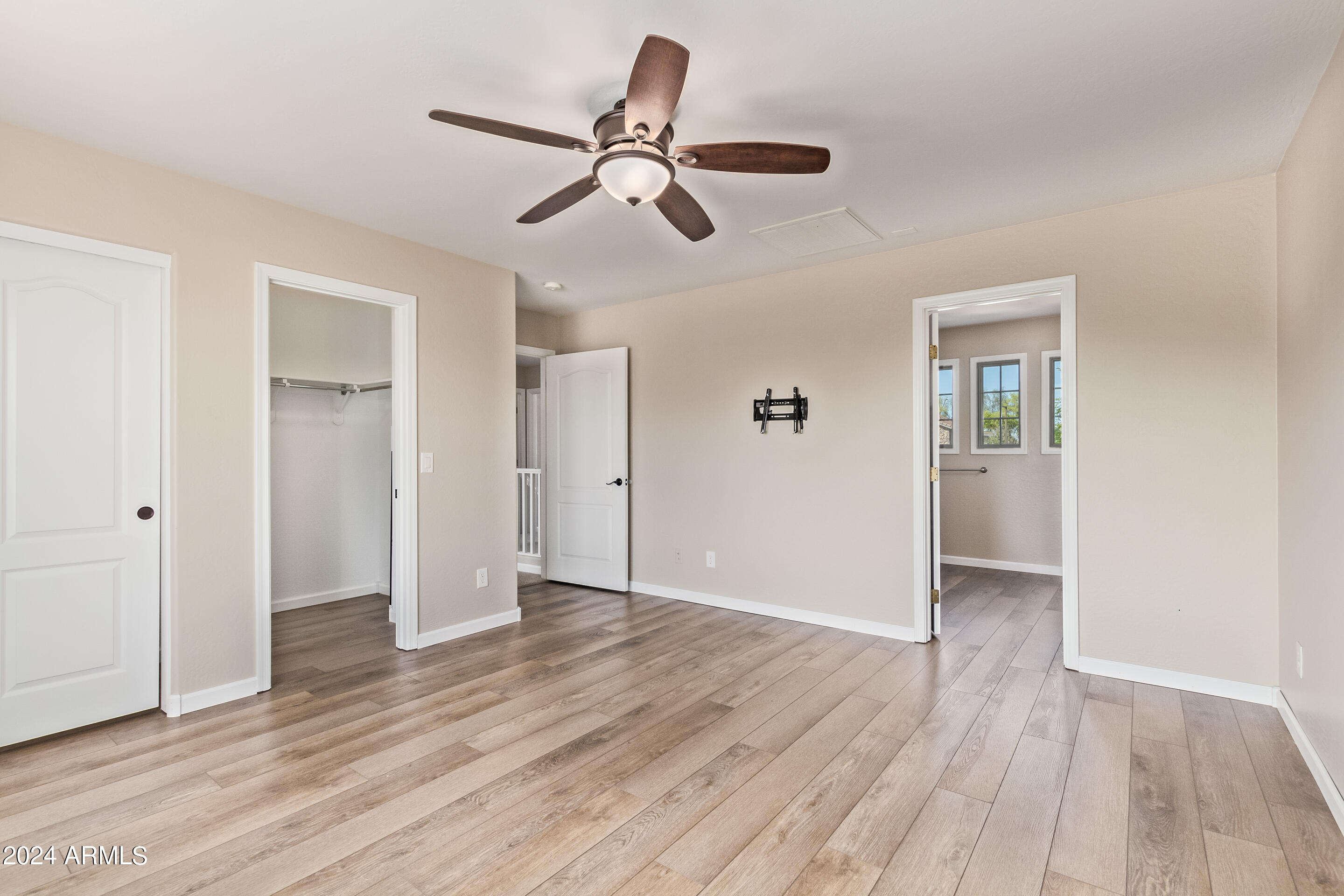 17149 West Rimrock Street Surprise, AZ 85388 - Photo 17 of 46 wooden floor in an empty room with a window