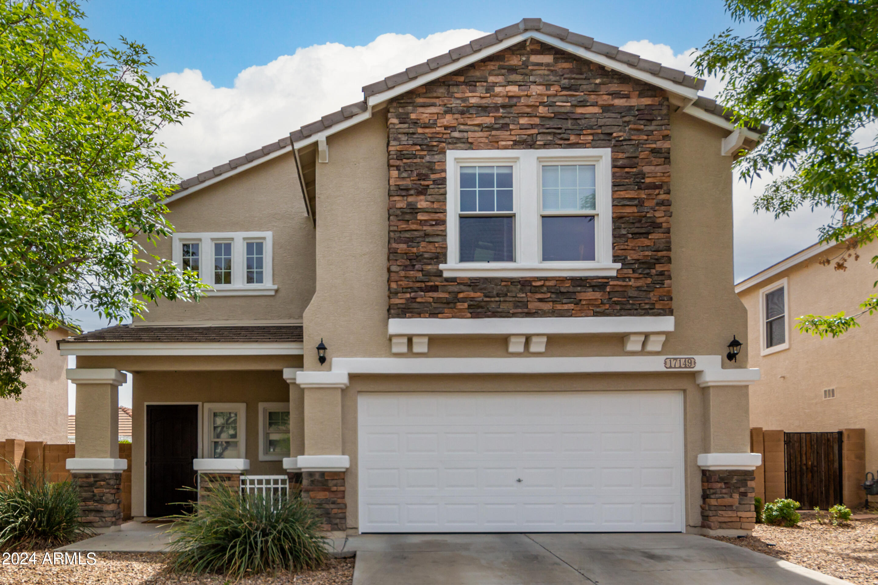 17149 West Rimrock Street Surprise, AZ 85388 - Photo 2 of 46 a front view of a house with garden