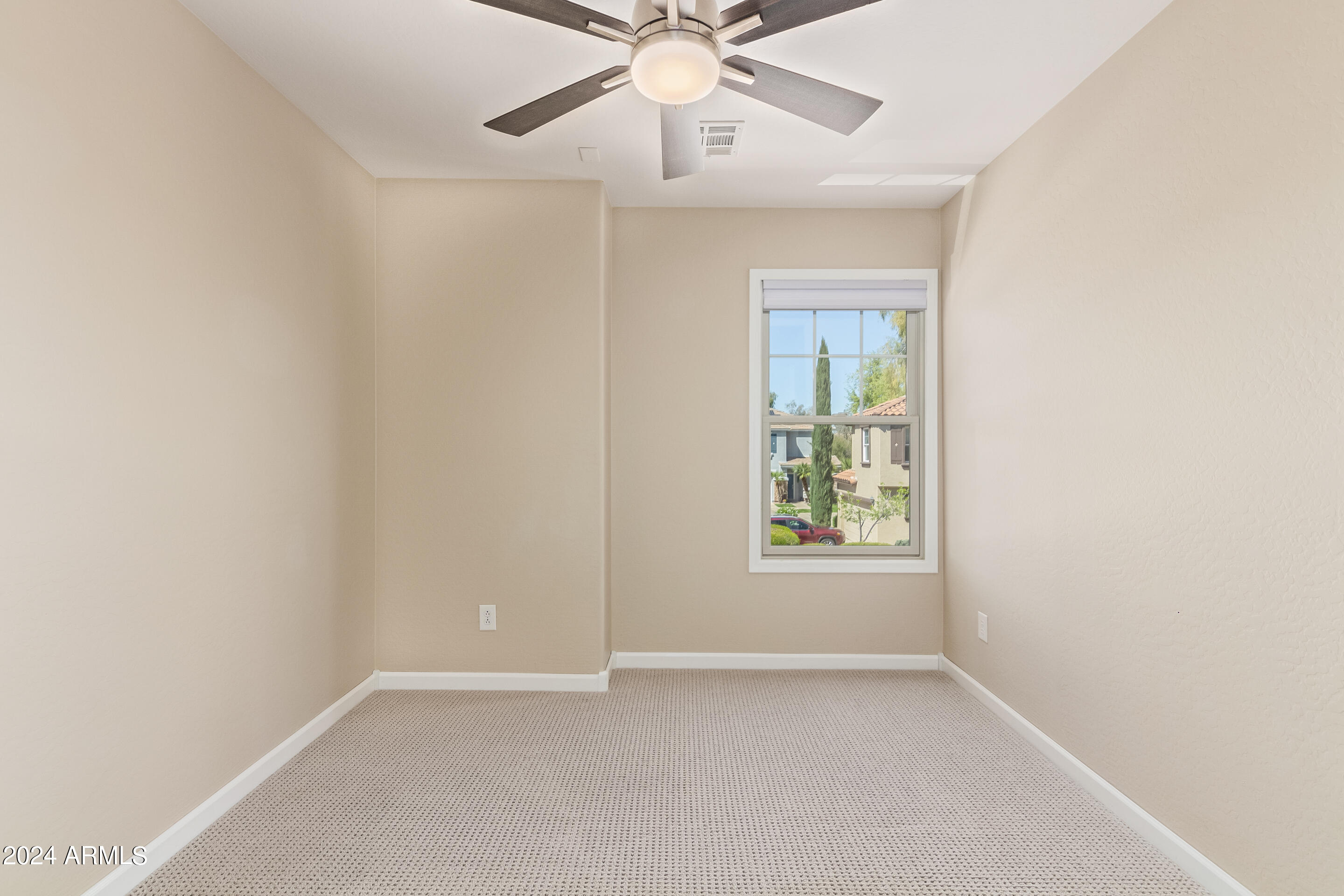17149 West Rimrock Street Surprise, AZ 85388 - Photo 22 of 46 an empty room with a window and a fan