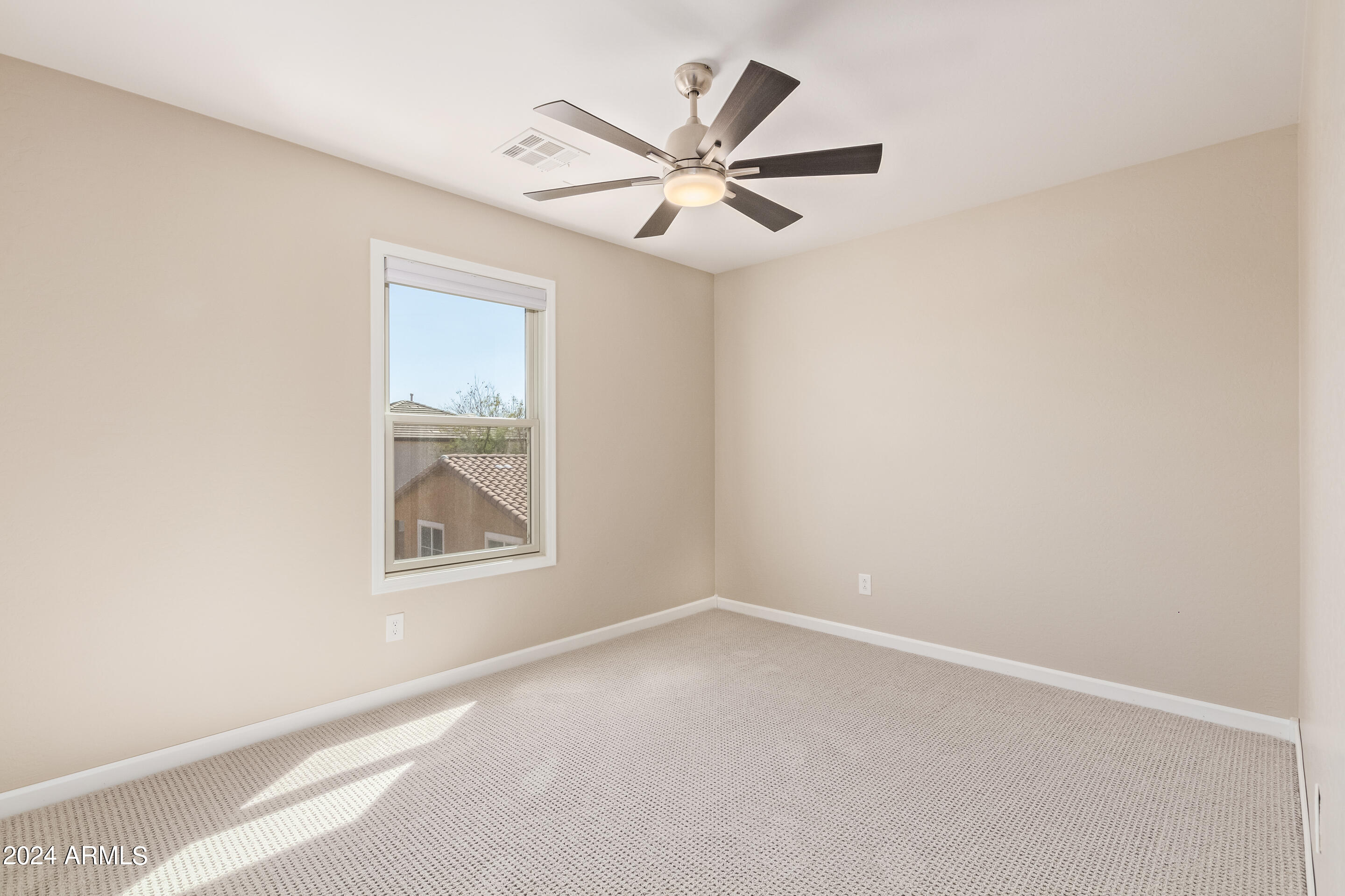 17149 West Rimrock Street Surprise, AZ 85388 - Photo 25 of 46 an empty room with a window and a ceiling fan