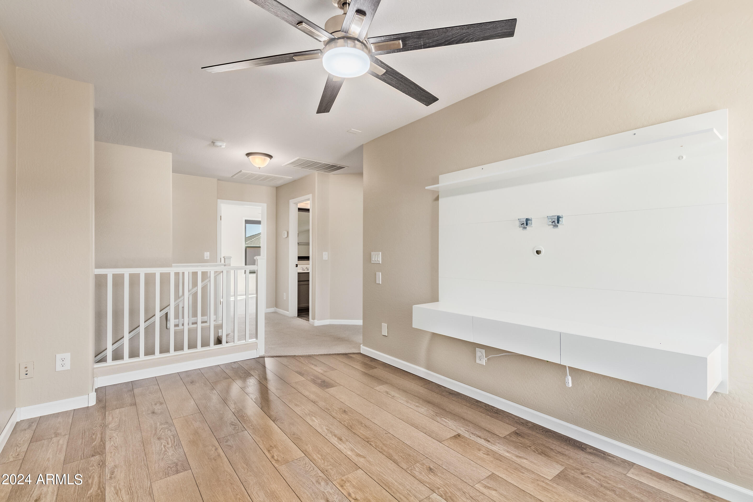 17149 West Rimrock Street Surprise, AZ 85388 - Photo 27 of 46 an empty room with wooden floor fan and windows
